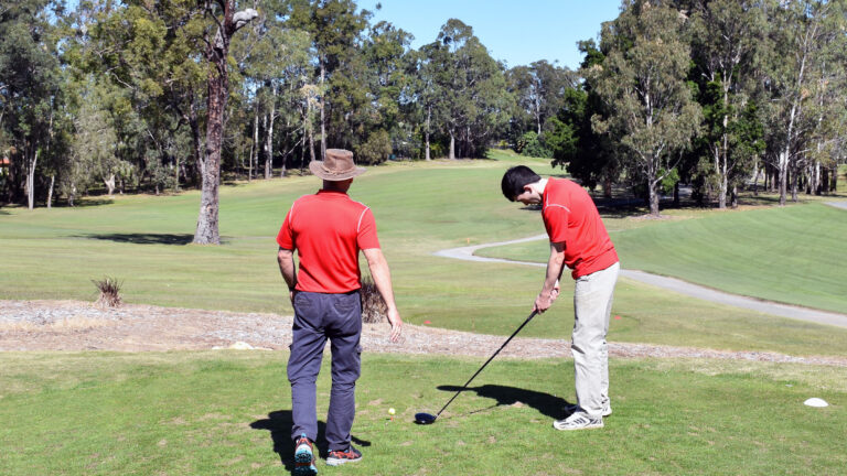 Queensland Blind Golf member Jock Young tprepares to tee up with his father Jock Young at the 2022 Queensland Blind Golf Open held at Parkwood on the Gold Coast